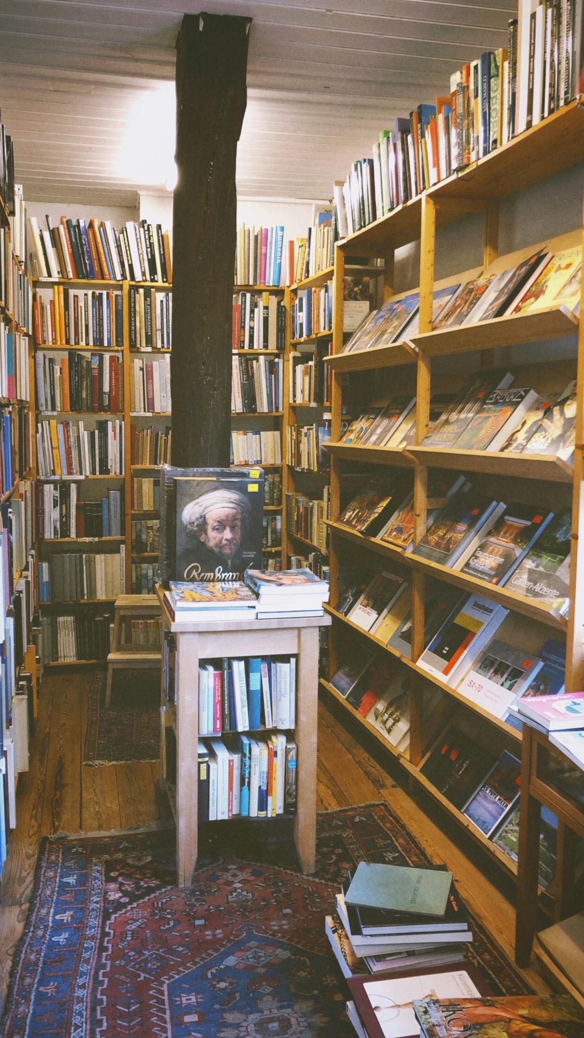 An inviting bookstore with wooden shelves filled with diverse books and a warm atmosphere.
